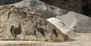 Two piles of aggregate on a quarry floor