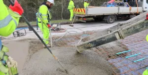 Men in PPE carry out repairs to the concrete road section of the M54