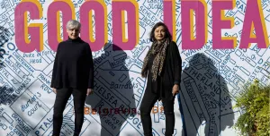 Ruth Sparkes and Sunita Gordon, co-founders of SaferSpace, dressed in black, photographed in harsh sunlight against a map of London with the slogan "Good Idea" printed over it.