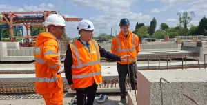 Three men in PPE, including Councillor Tony Eaton, chairman of Bassetlaw District Council, examine precast concrete elements in ABM Precast Solutions' yard during the company's 20th Anniversay celebrations.