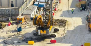 A view of a yellow Bauer piling rig at work on Cairo, Egypt's new metro station in Giza. In an estimated 14 months, Bauer Egypt will execute 209 diaphragm wall panels and 20 barrettes for Cairo's new metro station in the Giza district. Despite limited space and other challenges, work is progressing smoothly. Image: BAUER Group