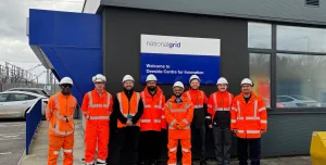 The Hyperion Robotics and National Grid teams, all in orange PPE, stand outside the Deeside Centre for Innovation, National Grid’s advanced testing facility in North Wales.