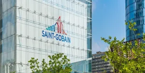 The blue and red Saint-Gobain logo on the side of a glass paneled, high-rise building.