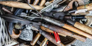 A bag of old hand tools with wooden handles