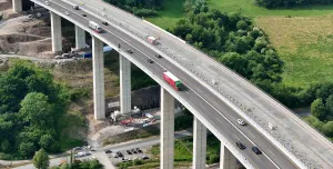 Workers monitor the precise hydraulic shift of the 40,000-tonne Rinsdorf viaduct, moved laterally into position in a German engineering first.