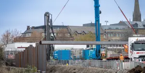 A blue piling rig installing sheet piles for the £4.4 million Rotherham Riverside upgrade