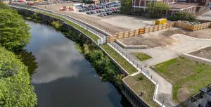 An aerial view of the completed riverside walkway in Rotherham links Water Lane to the town centre, supported by new sheet piling and concrete capping beams.