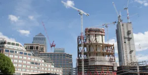 High rise buildings under construction with a tower crane and 1 Canada Wharf in the background