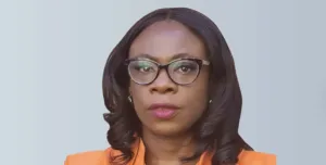 A head and shoulders picture of Ola Obadara FCIOB will serve as CIOB Vice President for 2025/26, the first black woman to hold the role, wearing an orange top and glasses with shoulder length hair