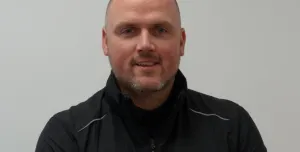 A bald man in a black fleece branded with the Bay-Lynx logo.