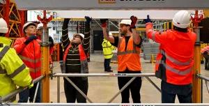A group of PPE glad people receive formwork training from PERI UK, which delivers hands-on, accredited formwork training at its Brentwood facility and nationwide.