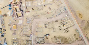 A drone shot of a new housing estate under construction showing the foundations of the new houses