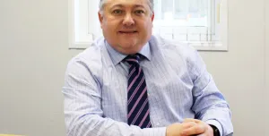 FPS chair Malcolm O’Sullivan sits at a desk facing the camera wearing a blue shirt and stripped tie. Malcolm has welcomed the £725bn infrastructure programme but warned of regulatory and workforce pressures.