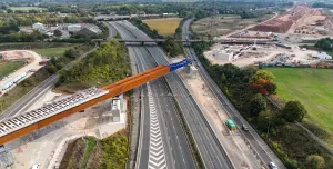 An aerial view of The HS2 viaduct East Deck being slid into place over the M6, supported by four pairs of reinforced concrete piers.