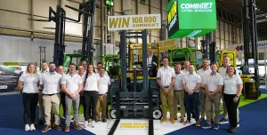 Combilift staff celebrate The 100,000th Combilift forklift, a golden Combi-CBE, was unveiled at IMHX 2025 in Birmingham.