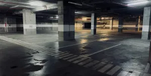 A dimly lit underground concrete carpark
