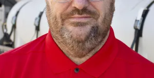 A head and shoulders photo of Steve Cartwright, General Manager, Volumech (Cemen Tech UK), in a red top, glasses, beard and greyish hair