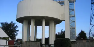 A view of a round concrete water tower and access tower