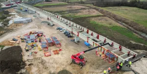 An under construction bridge in the countryside with construction machinery