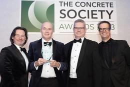 Four men holding an award