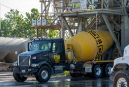 A blue and yellow concrete mixer truck