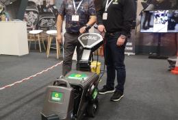 Two men standing in front of a floor stripper