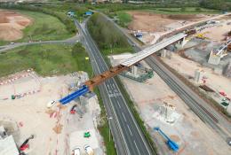 Aerial photo of a blue and brown viaduct under construction