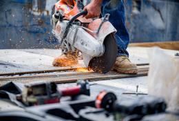 a close up of a circular saw cutting concrete