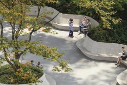 People sitting on crete seats in a park