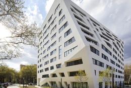 A white, 11 storey angular building