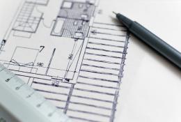 A black pen and a plan of a house with a white ruler