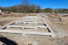 Concrete beams lying on the ground at a construction site