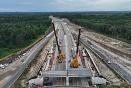 Two yellow cranes construct a new bridge