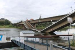 A side view of a collapsed road bridge