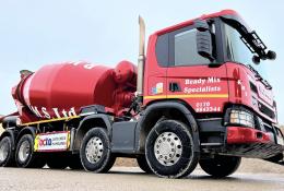 A bright red concrete mixer truck