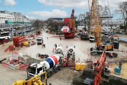 A crane, concrete mixer, excavator and other construction equipment helping pour concrete for the Austerlitz Basin in Paris