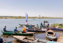 People in small boats help clear the River Nile as part of the VeryNile environmental initiative