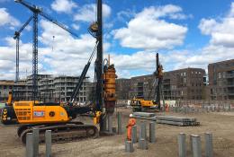 A yellow piling rig installing Precast Concrete Piles