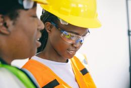 Two women in PPE.