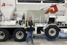 Derrick Murias, the new General Manager at ProAll, stand in front of a ProAll mixer.