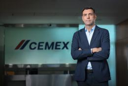 José Antonio Cabrera Cemex EMEA's new regional president stands with arms folded in front of a Cemex sign.