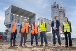 L–R: Prof. David Hughes; Bob Borthwick; Scott Bros recycling innovation engineer Feysal Shifa; Peter Scott; Joss Newberry; and Cassidy Smith, Teesside University’s IP and commercialization manager, standing in front of Scott Brothers new low-carbon concrete plant in Teeside.