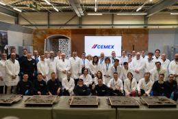 A group of people in white lab coats outside Cemex's GRD.