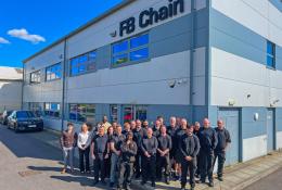 FB Chain employees celebrate 40 years of conveyor chain manufacture and innovation outside the company's factory.