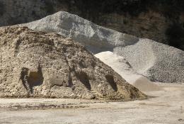 Two piles of aggregate on a quarry floor