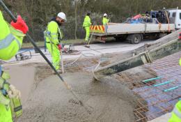 Men in PPE carry out repairs to the concrete road section of the M54