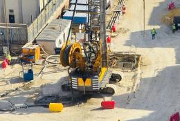 A view of a yellow Bauer piling rig at work on Cairo, Egypt's new metro station in Giza. In an estimated 14 months, Bauer Egypt will execute 209 diaphragm wall panels and 20 barrettes for Cairo's new metro station in the Giza district. Despite limited space and other challenges, work is progressing smoothly. Image: BAUER Group