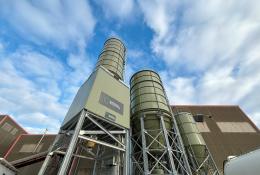 A view from the ground looking up at silos at Material Evolution's ultra-low carbon cement plant in Wrexham