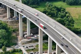 Workers monitor the precise hydraulic shift of the 40,000-tonne Rinsdorf viaduct, moved laterally into position in a German engineering first.