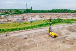 A yellow foundation rig prepares to start work at a large housing project in St Helens.